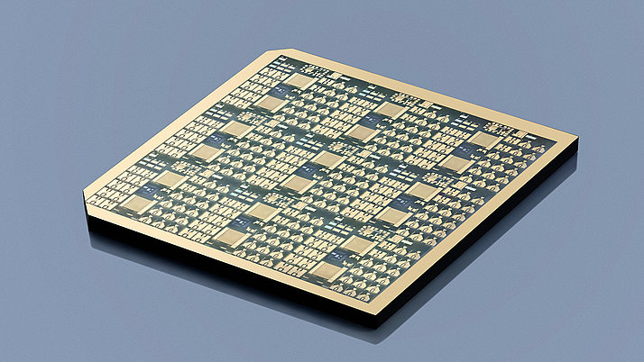 Wafer with a complex arrangement of circuits and components on a flat surface. 